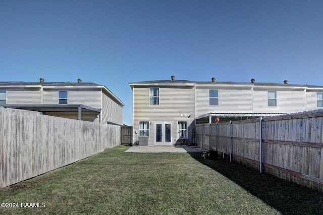 rear view of property with a lawn, a patio area, french doors, and central air condition unit