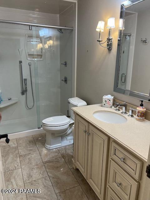 bathroom with walk in shower, vanity, and toilet