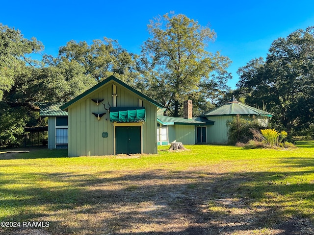 view of outbuilding with a yard