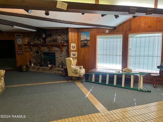 unfurnished living room with vaulted ceiling with beams, wood walls, a fireplace, and carpet