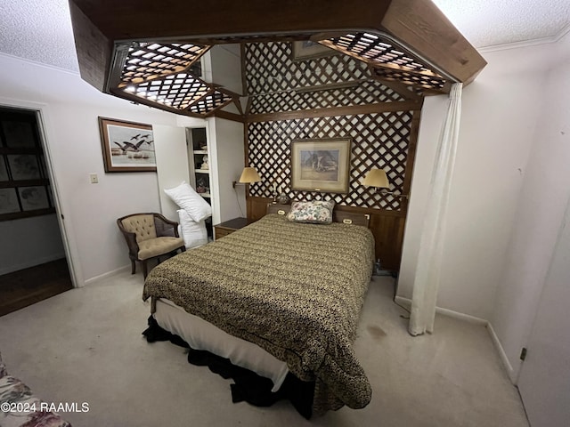 carpeted bedroom with crown molding and a textured ceiling