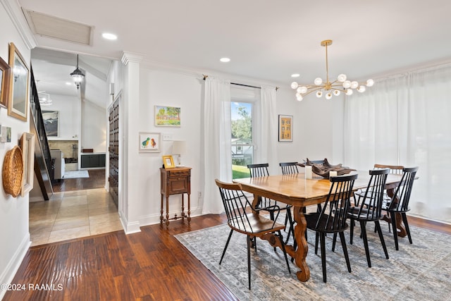 dining space with crown molding, dark hardwood / wood-style flooring, and a notable chandelier