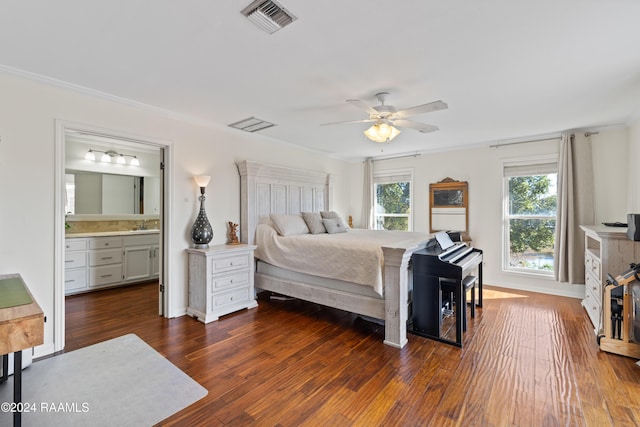 bedroom with ensuite bath, ceiling fan, sink, dark hardwood / wood-style flooring, and ornamental molding