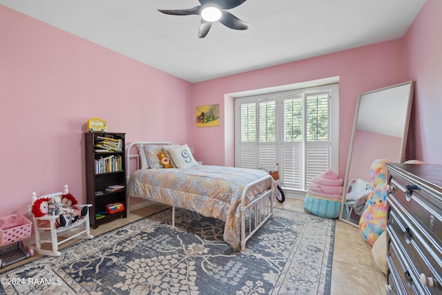 tiled bedroom featuring ceiling fan