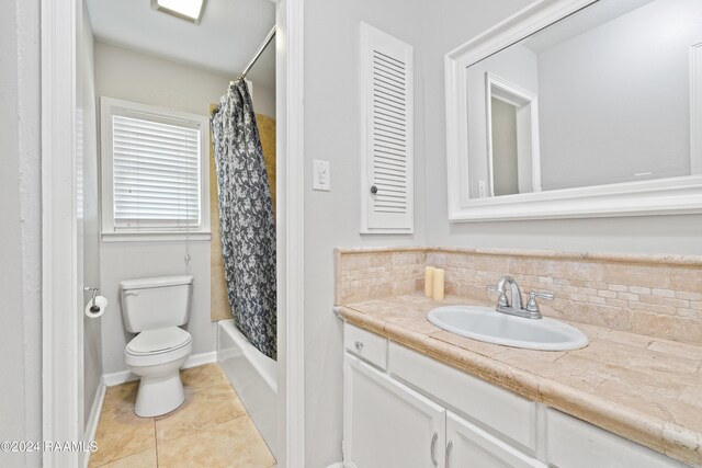 full bathroom featuring shower / bathtub combination with curtain, tile patterned flooring, toilet, decorative backsplash, and vanity