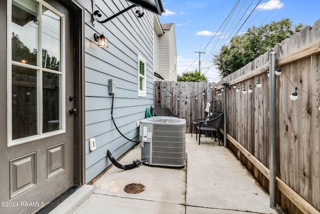 view of side of property featuring a patio area and cooling unit