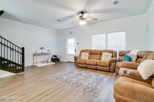 living room featuring crown molding, light hardwood / wood-style flooring, and ceiling fan