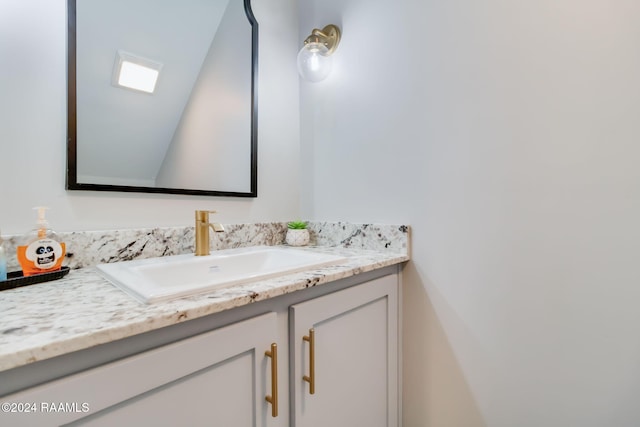 bathroom featuring vanity and vaulted ceiling