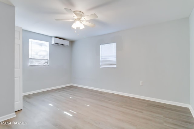 807 American Legion Dr, Rayne, LA 70578 - spare room featuring a wall unit AC, ceiling fan, and wood finished floors