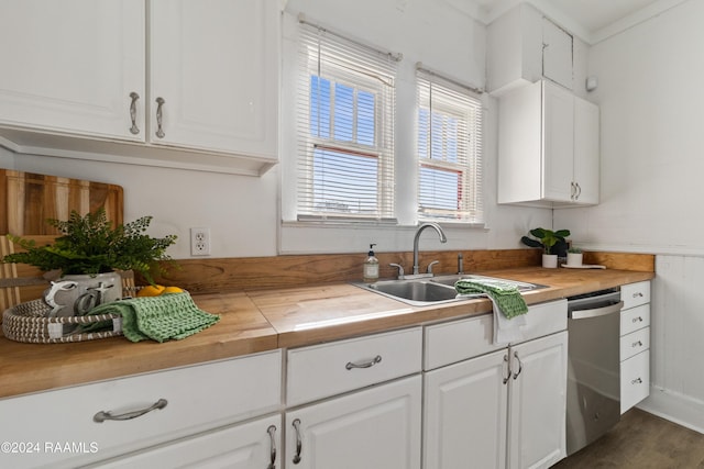 kitchen featuring dishwasher, white cabinetry, dark wood-type flooring, and sink