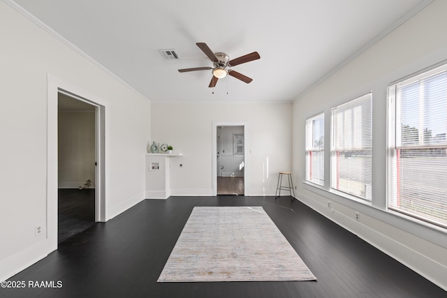 spare room featuring crown molding, ceiling fan, and dark wood-type flooring