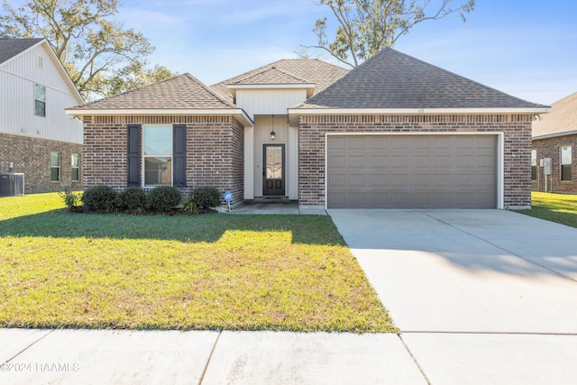 view of front facade featuring central AC unit, a garage, and a front lawn