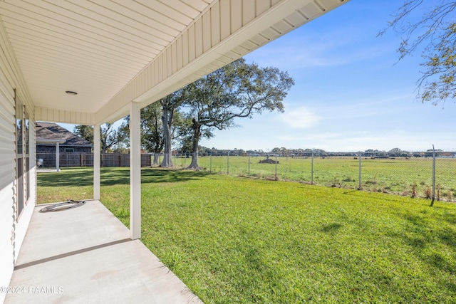 view of yard featuring a rural view and a patio