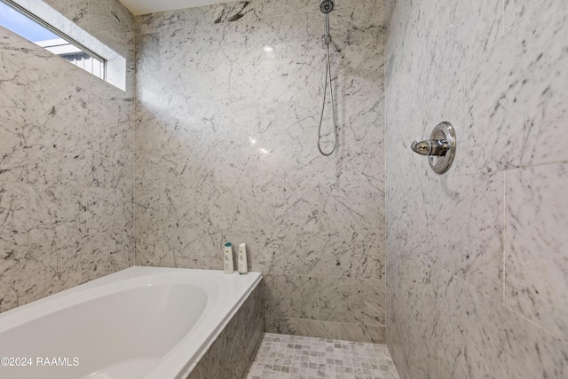 bathroom featuring shower with separate bathtub