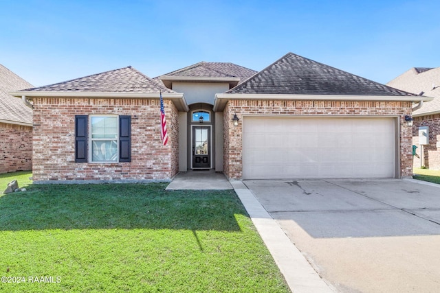 view of front of property featuring a garage and a front yard