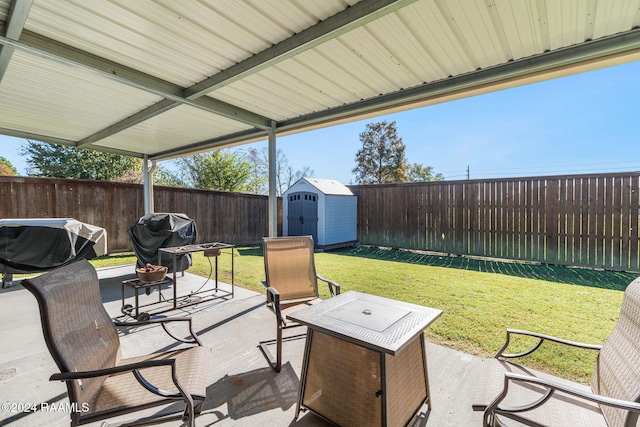 view of patio featuring area for grilling and a storage unit