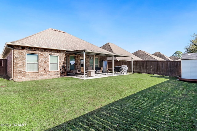 rear view of property with a lawn and a patio area