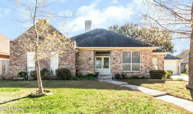 view of front of property featuring a garage and a front yard