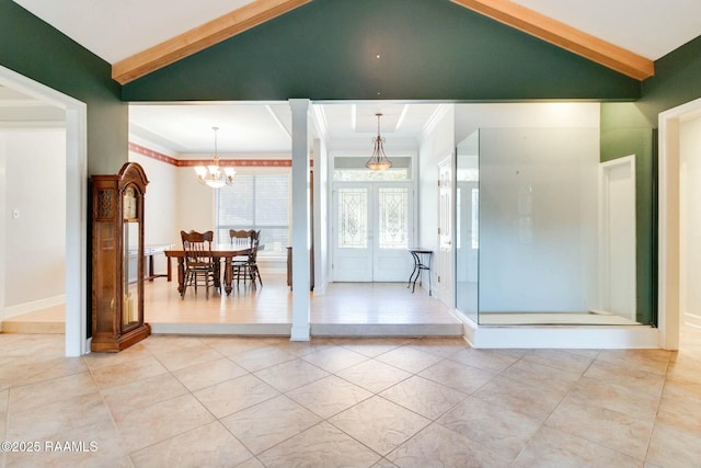 interior space featuring ornamental molding, lofted ceiling, french doors, and an inviting chandelier