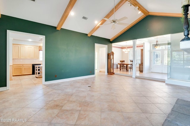 unfurnished living room with vaulted ceiling with beams and ceiling fan with notable chandelier