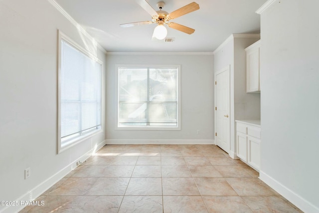 unfurnished dining area featuring crown molding, ceiling fan, and light tile patterned floors