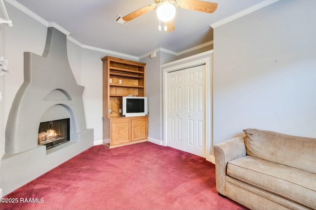 carpeted living room with ceiling fan and crown molding