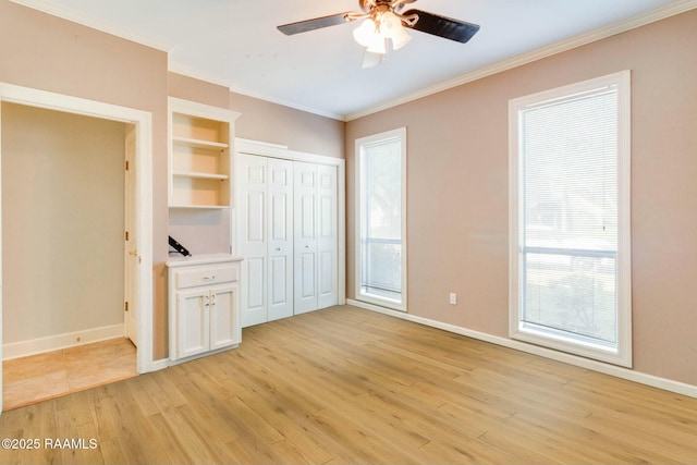 unfurnished bedroom with multiple windows, light hardwood / wood-style floors, ceiling fan, and ornamental molding