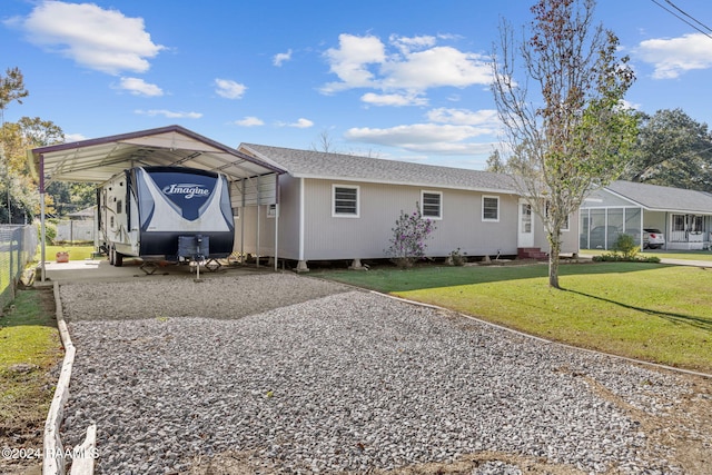 view of front of home featuring a front lawn and a carport