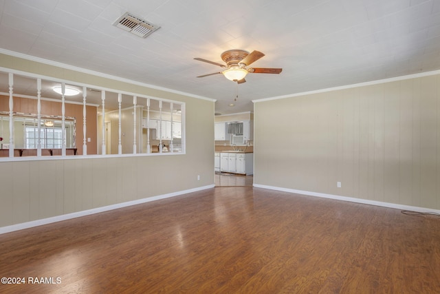 903 S Shireview Cir, Abbeville, LA 70510 - unfurnished living room featuring a ceiling fan, wood finished floors, and crown molding