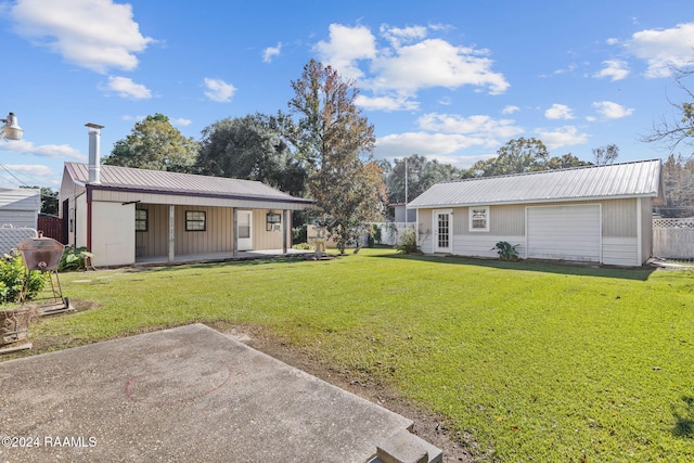 903 S Shireview Cir, Abbeville, LA 70510 - back of property with a metal roof, a porch, and an outdoor structure