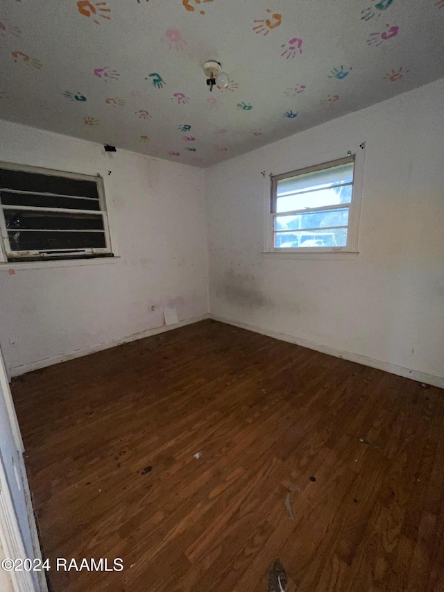 empty room featuring dark hardwood / wood-style flooring