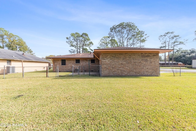 back of property featuring a yard