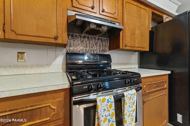 kitchen featuring black fridge and stainless steel gas range