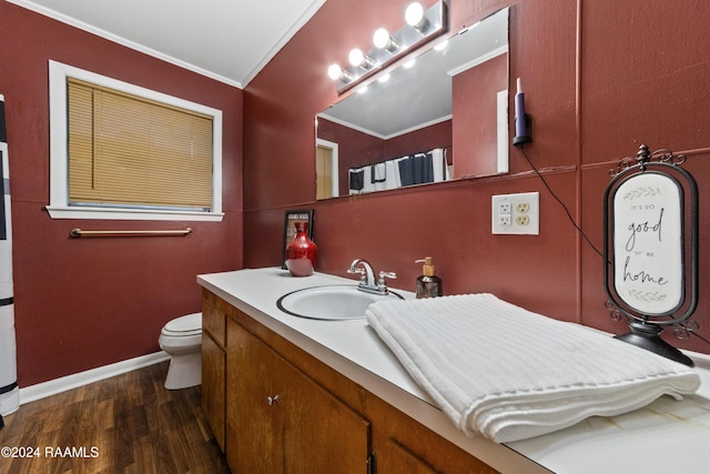 bathroom featuring hardwood / wood-style floors, vanity, toilet, and ornamental molding