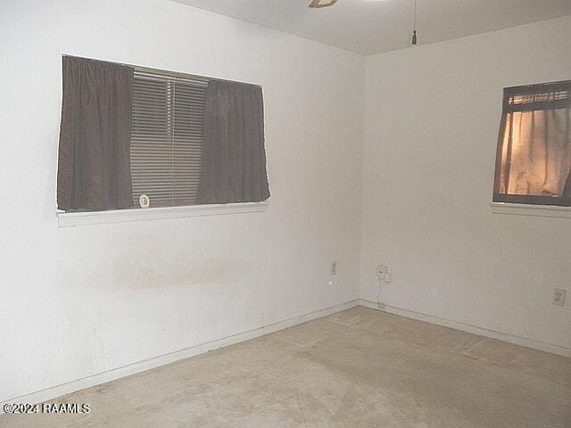 carpeted empty room with ceiling fan