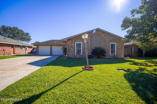 ranch-style home with a front yard and a garage