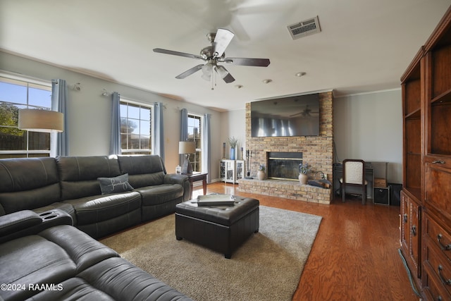 living room with ceiling fan, dark hardwood / wood-style flooring, a fireplace, and crown molding