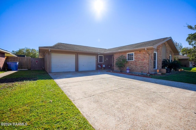 ranch-style house featuring a front yard and a garage