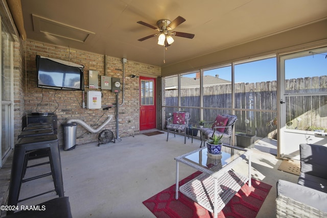 sunroom featuring ceiling fan