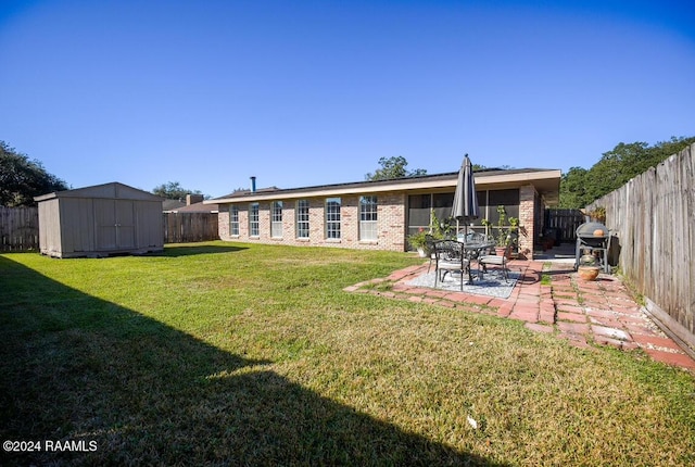 view of yard featuring a storage shed and a patio area