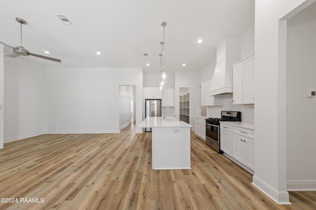 kitchen featuring sink, white cabinets, stainless steel appliances, and light hardwood / wood-style floors