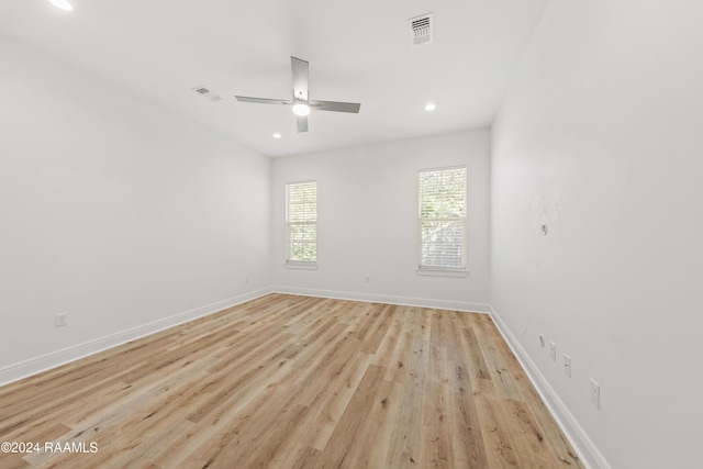 empty room with light hardwood / wood-style flooring and ceiling fan