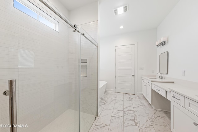 bathroom featuring vanity and shower with separate bathtub