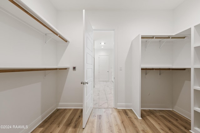 walk in closet featuring light wood-type flooring