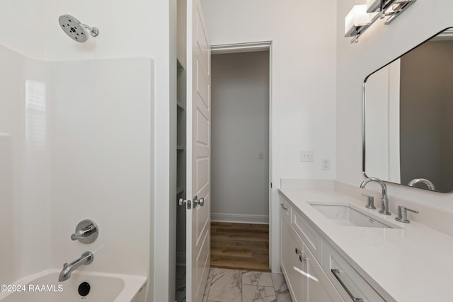 bathroom featuring shower / washtub combination and vanity