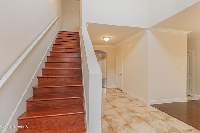 stairs featuring crown molding