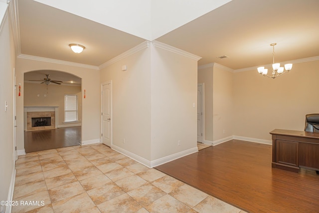 interior space featuring crown molding, pendant lighting, and ceiling fan with notable chandelier