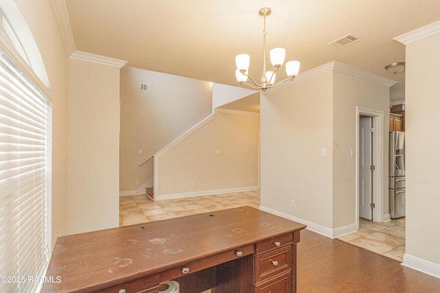 interior space featuring ornamental molding, a chandelier, and light hardwood / wood-style flooring