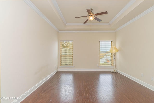 unfurnished room featuring crown molding, ceiling fan, a tray ceiling, and dark wood-type flooring