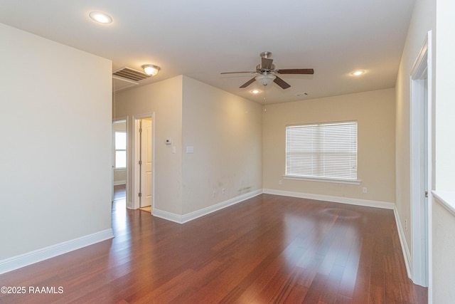 spare room featuring dark wood-type flooring and ceiling fan